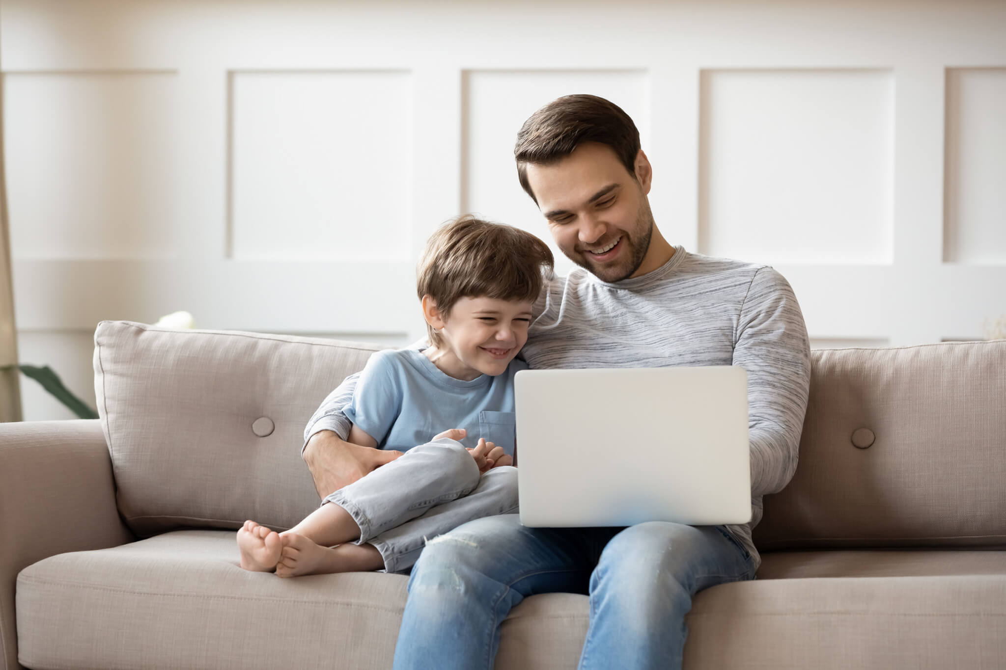Little boy relax with father using laptop